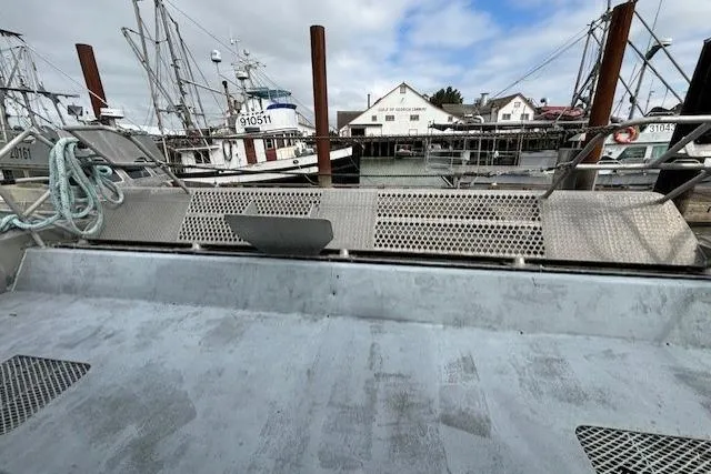 Western Shore Yacht Photos Pics Fishing boat deck with metal grates, Custom Expedition 1989, docked at a marina.
