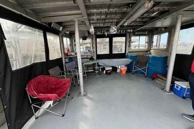 Western Shore Yacht Photos Pics Interior of a 1989 Custom Expedition boat with chairs and fishing gear.