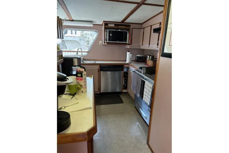 Western Shore Yacht Photos Pics 1989 Custom Expedition kitchen with modern appliances, featuring a microwave, dishwasher, and ample counter space.