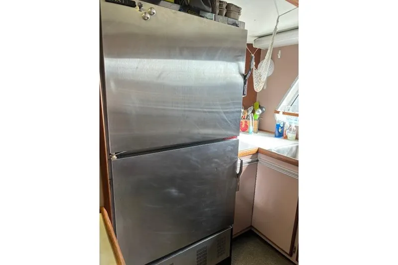 Western Shore Yacht Photos Pics Stainless steel refrigerator in a kitchen, Custom Expedition model, 1989.