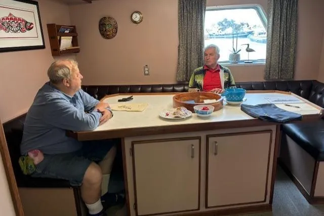 Western Shore Yacht Photos Pics Two men conversing in a cozy boat cabin, 1989 Custom Expedition.
