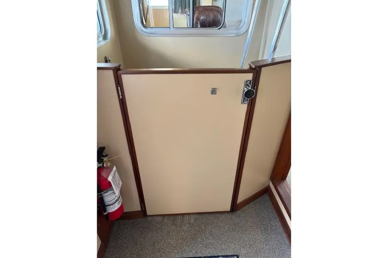 Western Shore Yacht Photos Pics Interior of 1989 Custom Expedition with beige door and fire extinguisher.