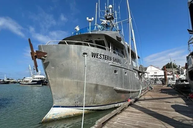 Western Shore Yacht Photos Pics 1989 Custom Expedition boat "Western Shore" docked at a marina under a clear blue sky.