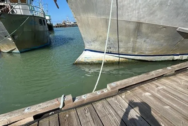 Western Shore Yacht Photos Pics Docked boats in harbor, Custom Expedition 1989, with shadow on wooden pier.