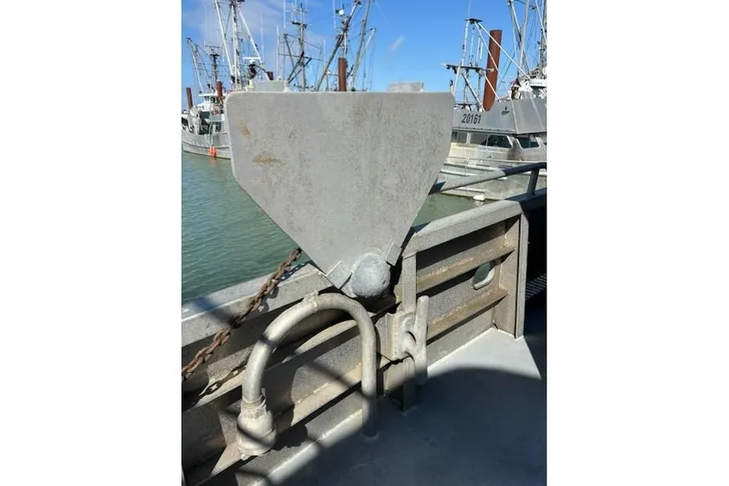 Western Shore Yacht Photos Pics Metal structure on a boat deck with fishing vessels in the background, Custom Expedition 1989.