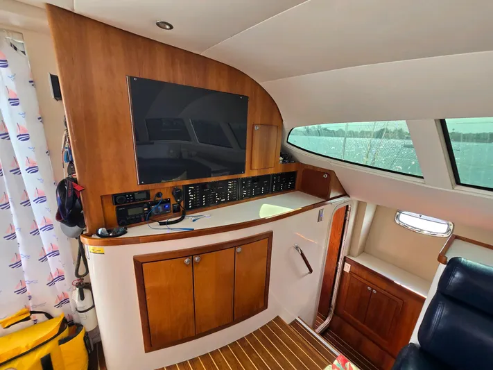 Alacrity Yacht Photos Pics Interior of 2009 Fusion 40 boat with wooden cabinetry and control panel.
