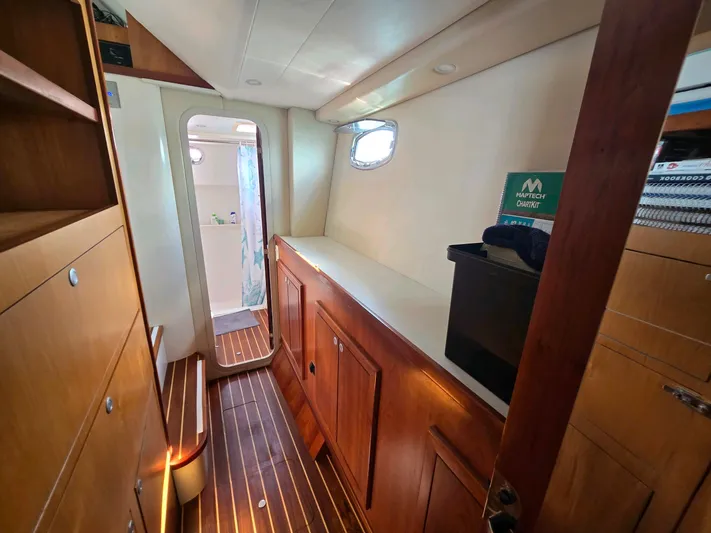 Alacrity Yacht Photos Pics Interior of 2009 Fusion 40 yacht with wooden cabinetry and flooring.