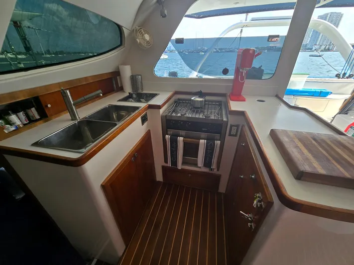 Alacrity Yacht Photos Pics Luxurious 2009 Fusion 40 yacht kitchen with ocean view, featuring modern appliances and wood accents.