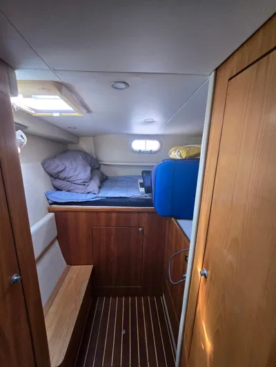 Alacrity Yacht Photos Pics Cozy cabin interior of 2009 Fusion 40 yacht with wooden finishes and bedding.