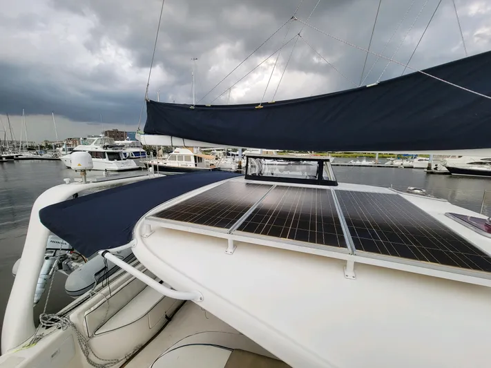 Alacrity Yacht Photos Pics 2009 Fusion 40 catamaran with solar panels docked at marina under cloudy sky.