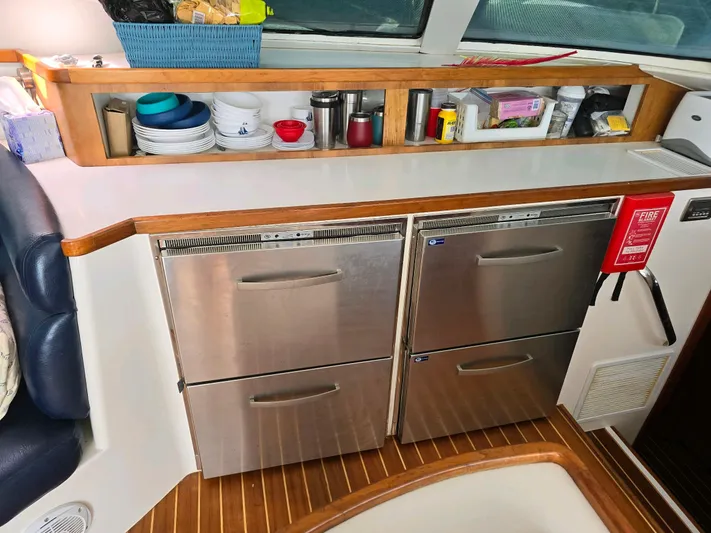 Alacrity Yacht Photos Pics 2009 Fusion 40 yacht kitchen with stainless steel appliances and wooden accents.