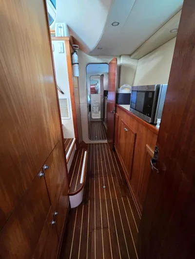 Alacrity Yacht Photos Pics Interior of 2009 Fusion 40 yacht with wooden cabinetry and striped flooring.