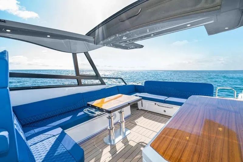  Yacht Photos Pics Luxurious 2023 Bavaria Vida 33 yacht interior with blue seating and ocean view.