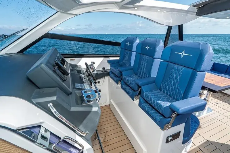  Yacht Photos Pics 2023 Bavaria Vida 33 yacht cockpit with blue seats and ocean view.