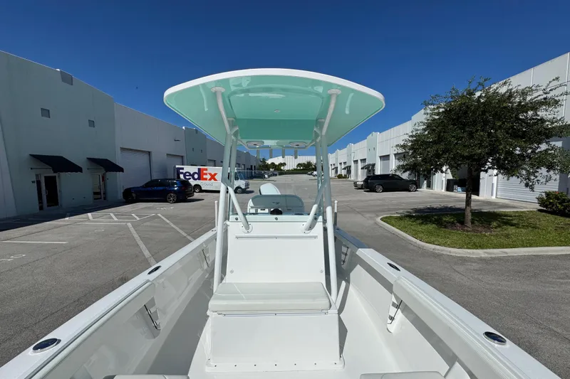  Yacht Photos Pics 2024 Albury Brothers 23 Forward Seating boat in a parking lot, under clear blue sky.