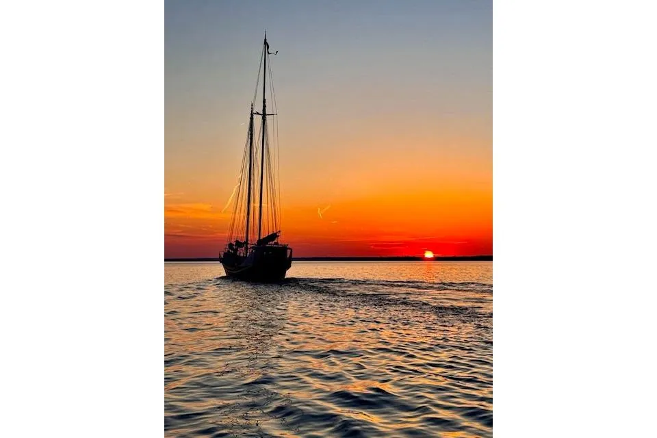 Schooner sailing at sunset, 1989 Custom Live aboard, tranquil ocean scene.