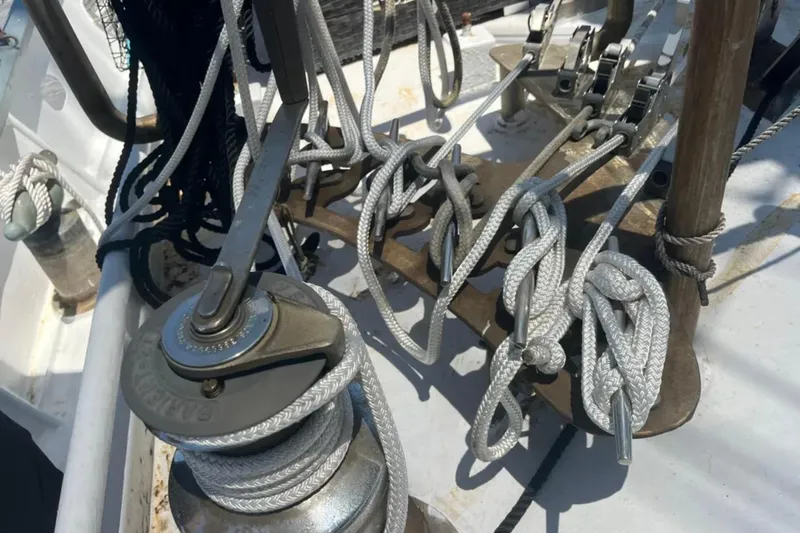Dauntless Yacht Photos Pics Ropes and winch on 1989 Custom Schooner Live aboard deck, showcasing nautical equipment.