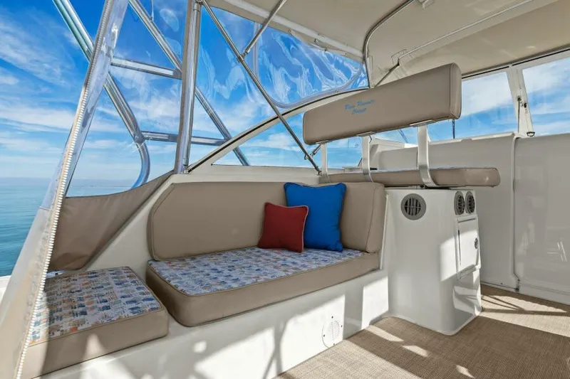 Whattakeeper Yacht Photos Pics 2006 Mainship 34 Rum Runner II interior with cushioned seating and ocean view.