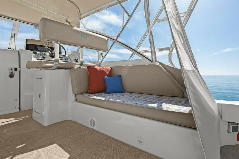 Whattakeeper Yacht Photos Pics 2006 Mainship 34 Rum Runner II interior with cushioned seating and ocean view.