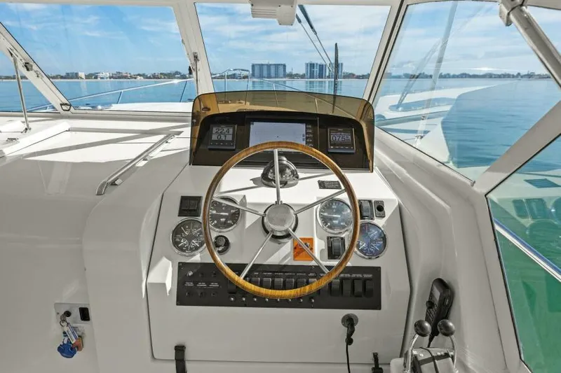 Whattakeeper Yacht Photos Pics Helm of 2006 Mainship 34 Rum Runner II with ocean view and navigational instruments.