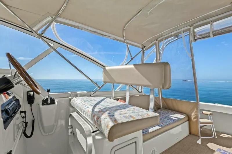 Whattakeeper Yacht Photos Pics 2006 Mainship 34 Rum Runner II interior with ocean view, featuring helm and seating area.