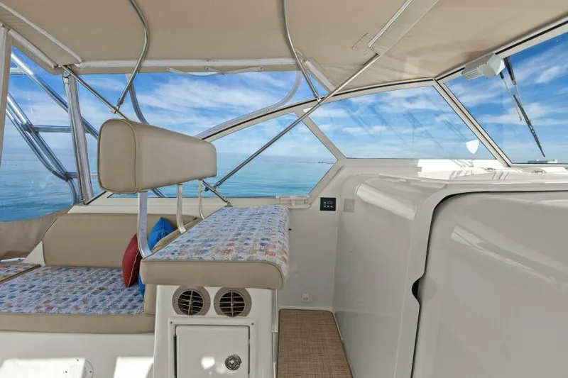 Whattakeeper Yacht Photos Pics 2006 Mainship 34 Rum Runner II interior with ocean view, featuring seating and helm area.