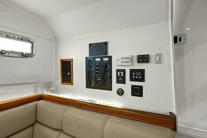 Whattakeeper Yacht Photos Pics Interior of 2006 Mainship 34 Rum Runner II with control panel and beige seating.