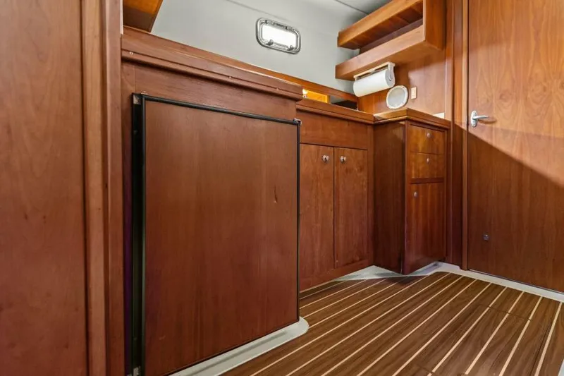 Whattakeeper Yacht Photos Pics 2006 Mainship 34 Rum Runner II interior with wooden cabinetry and flooring.
