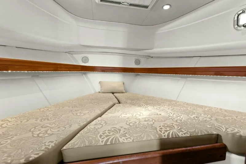 Whattakeeper Yacht Photos Pics 2006 Mainship 34 Rum Runner II cabin with patterned bedding and wooden accents.
