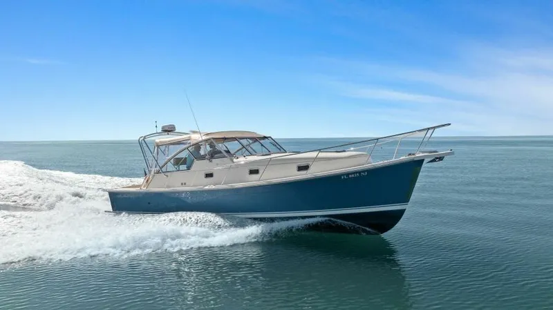 Whattakeeper Yacht Photos Pics 2006 Mainship 34 Rum Runner II cruising on calm ocean waters.