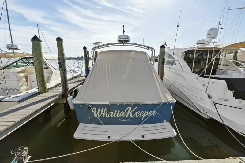 Whattakeeper Yacht Photos Pics 2006 Mainship 34 Rum Runner II docked, covered, with "Whatta Keeper" on the stern.