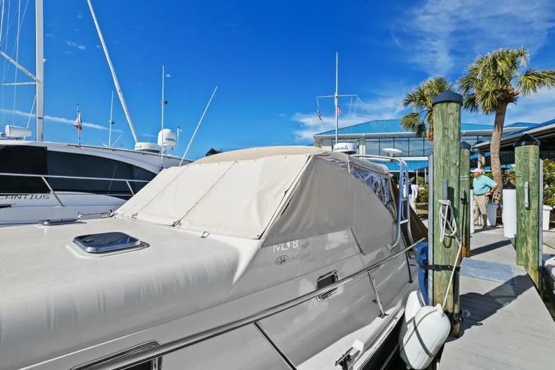 Whattakeeper Yacht Photos Pics 2006 Mainship 34 Rum Runner II docked at marina under clear blue sky.