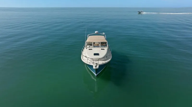Whattakeeper Yacht Photos Pics 2006 Mainship 34 Rum Runner II cruising on calm ocean waters.