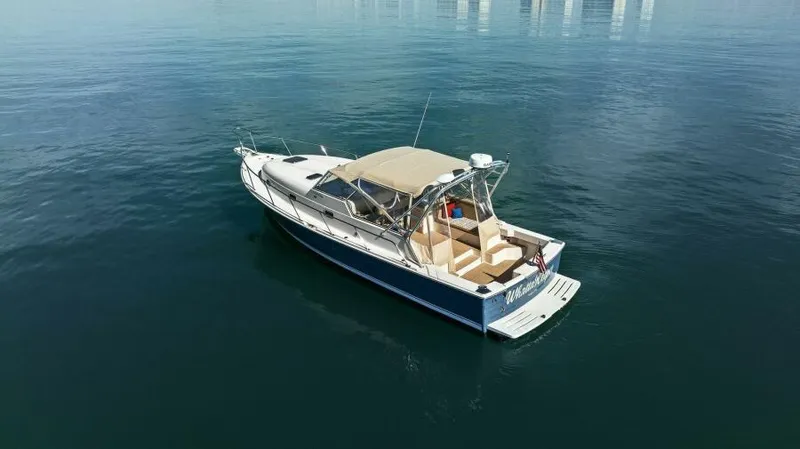 Whattakeeper Yacht Photos Pics 2006 Mainship 34 Rum Runner II boat on calm water, aerial view.