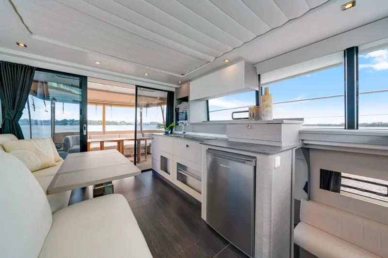  Yacht Photos Pics Luxurious interior of 2023 Fountaine Pajot MY4.S yacht with modern kitchen and seating area.