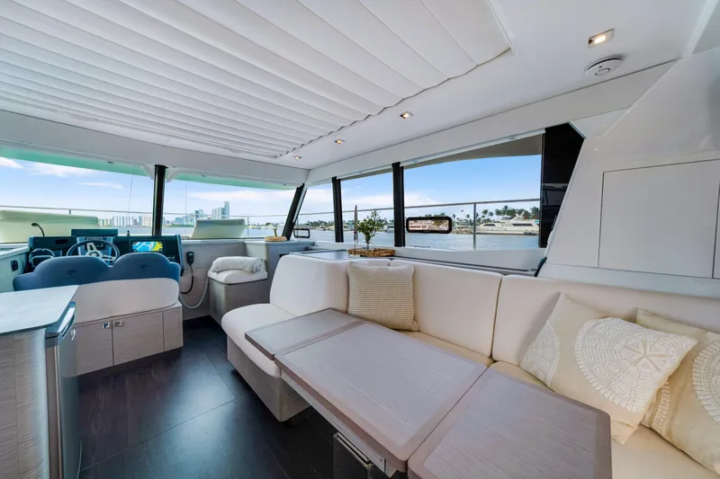  Yacht Photos Pics Luxurious interior of 2023 Fountaine Pajot MY4.S yacht with elegant seating and panoramic windows.