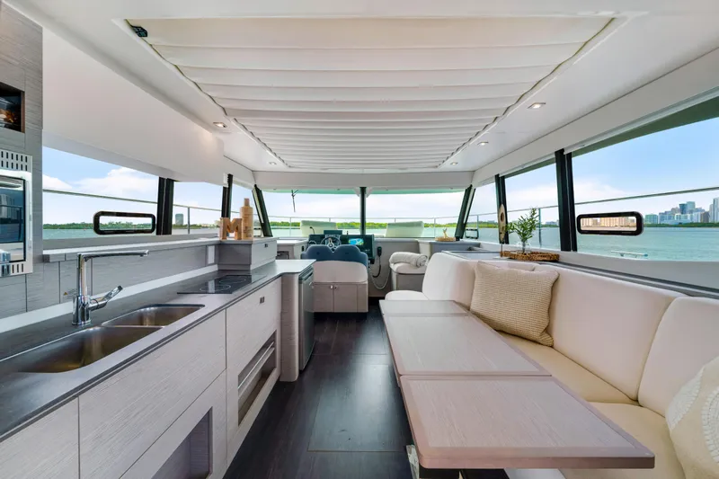  Yacht Photos Pics Luxurious interior of 2023 Fountaine Pajot MY4.S yacht with modern kitchen and seating area.