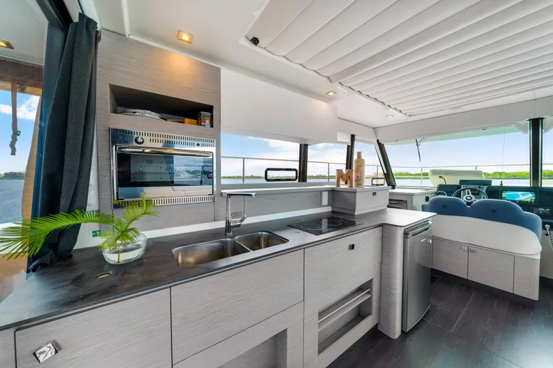  Yacht Photos Pics Modern kitchen interior of 2023 Fountaine Pajot MY4.S yacht with sleek design and appliances.