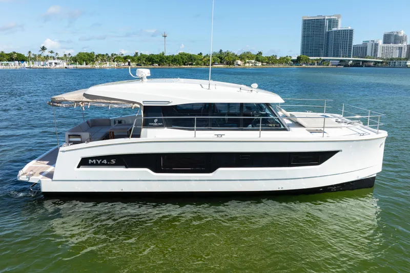  Yacht Photos Pics 2023 Fountaine Pajot MY4.S yacht on calm water, modern design, cityscape background.