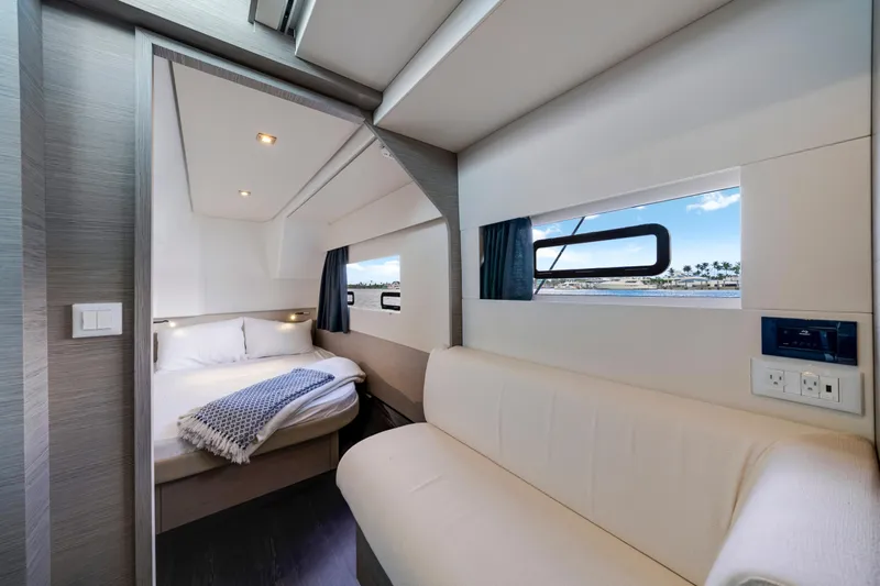  Yacht Photos Pics Luxurious interior of 2023 Fountaine Pajot MY4.S yacht with cozy bedroom and scenic window view.
