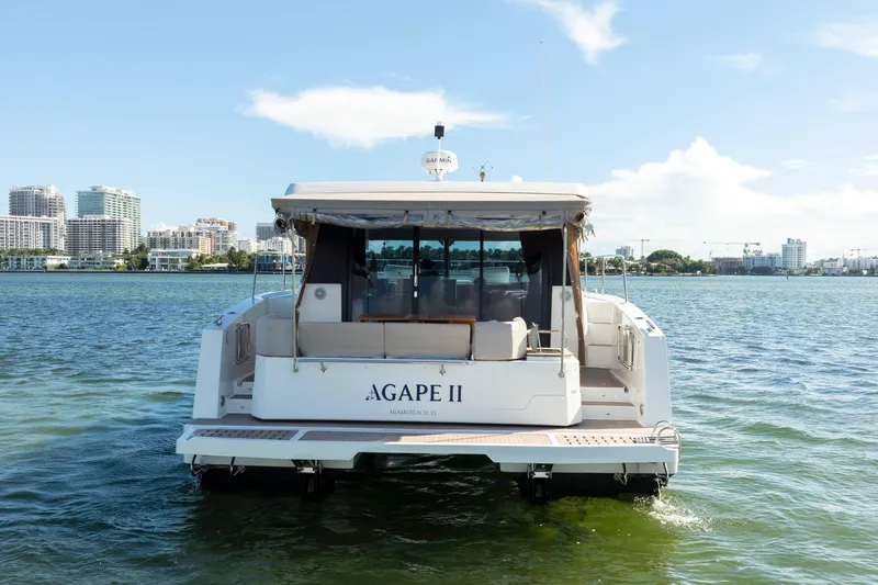  Yacht Photos Pics 2023 Fountaine Pajot MY4.S yacht on water, city skyline in background.