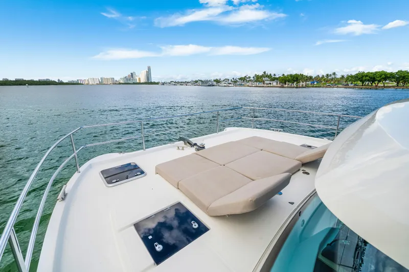  Yacht Photos Pics 2023 Fountaine Pajot MY4.S yacht deck with sunbed, overlooking scenic waterfront.