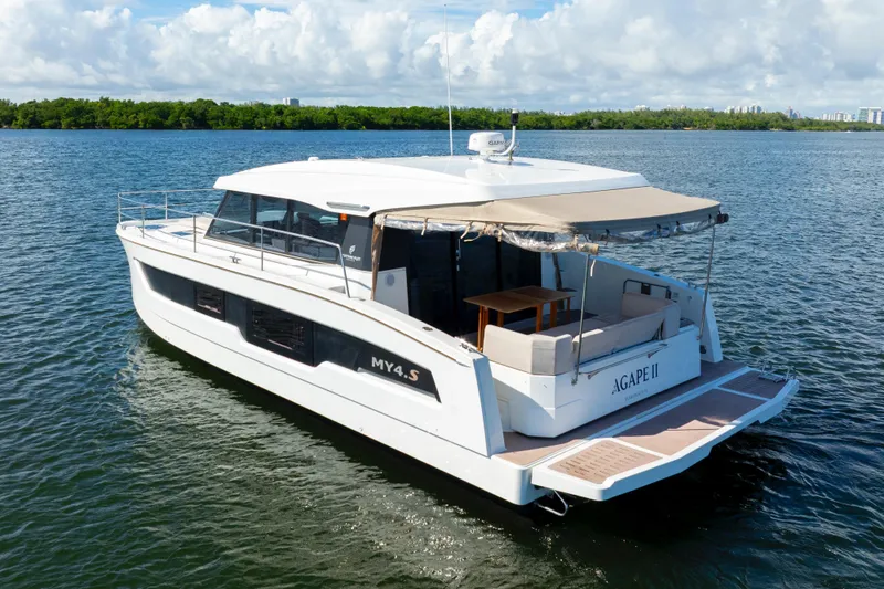  Yacht Photos Pics 2023 Fountaine Pajot MY4.S yacht on serene water, featuring spacious deck and modern design.