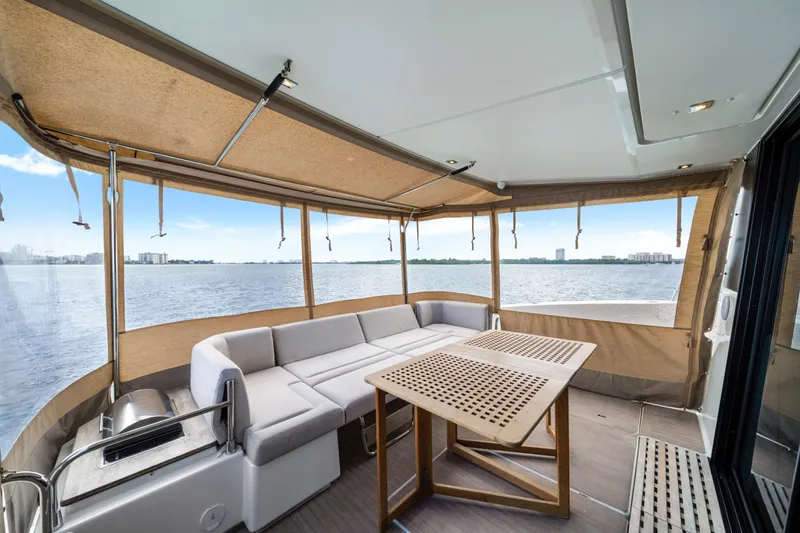  Yacht Photos Pics 2023 Fountaine Pajot MY4.S yacht interior with seating and table, overlooking water.