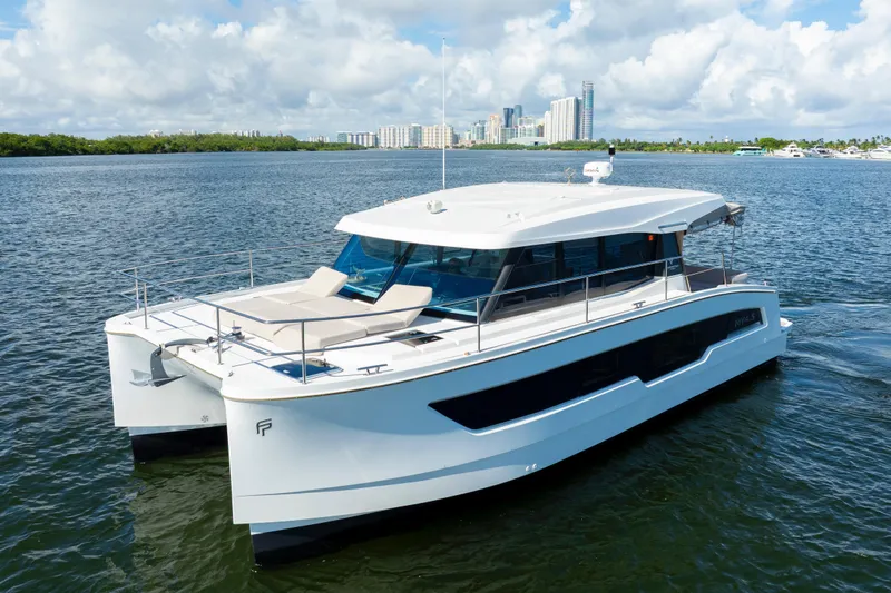  Yacht Photos Pics 2023 Fountaine Pajot MY4.S yacht on water with city skyline background.