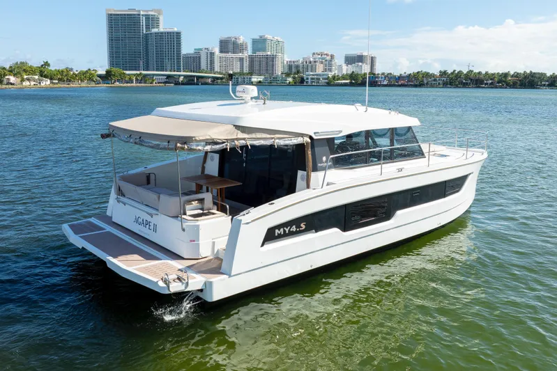  Yacht Photos Pics 2023 Fountaine Pajot MY4.S yacht on water with city skyline in background.