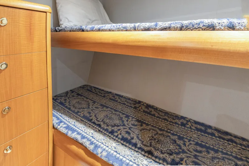Custom Yacht Photos Pics Bunk beds with patterned bedding in a 2005 Weaver 61 interior.