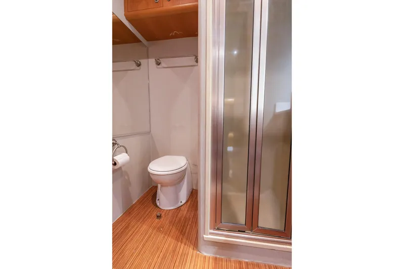 Custom Yacht Photos Pics Compact bathroom in 2005 Weaver 61 with toilet and shower.