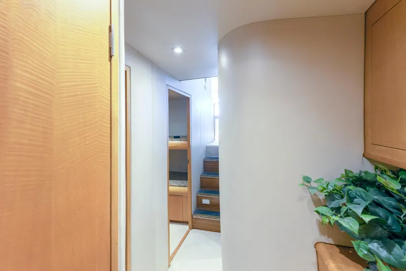 Custom Yacht Photos Pics Interior hallway of 2005 Weaver 61 yacht with wooden accents and potted plant.