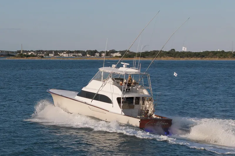 Custom Yacht Photos Pics Sportfishing boat Weaver 61, 2005 model, cruising on open water near coastline.